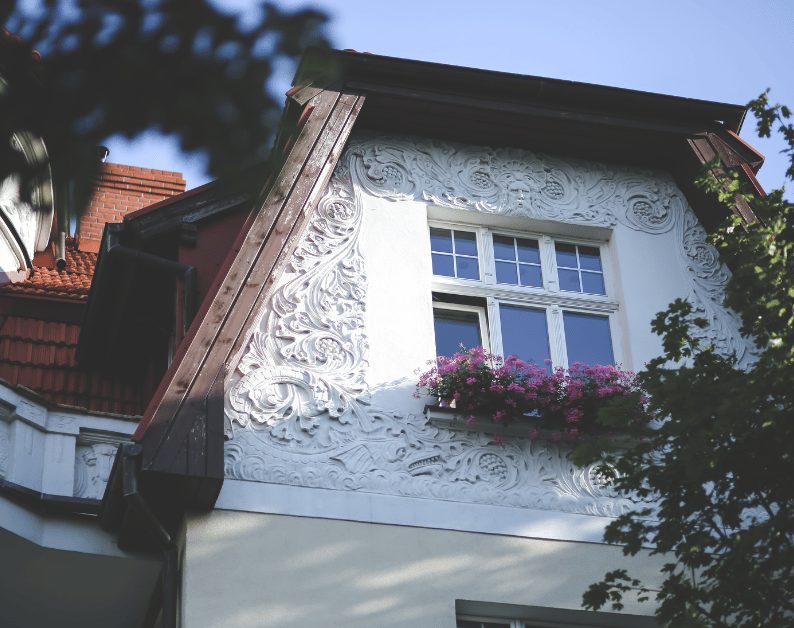 Stucco home exterior with tile roof detail