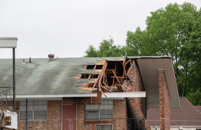 Roof with visible storm damage to decking and shingles